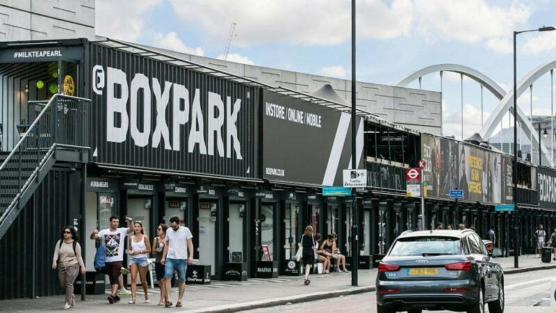 People walking in the street in front of BoxPark