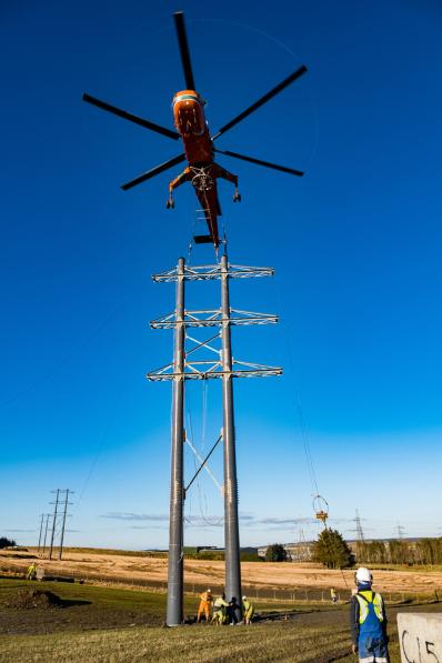 Erickson S-64 Air Crane helicopter installing the new composite poles