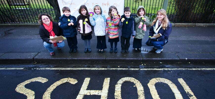 6 school kids and 2 teachers at the side of the road