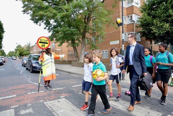 pedestrians crossing a zebra crossing in London
