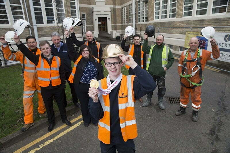 Cycling gold medallist trades helmet for hard hat as he receives hero’s homecoming