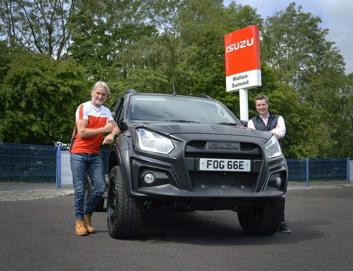 Former motorbike racing world champion Carl Fogarty has collected the keys to his new Isuzu D-Max XTR from Walton Summit Truck Centre in Lancashire. Featuring a custom designed body kit, a sophisticated and sporty interior, performance brakes and a bespoke Pedders suspension arrangement, the XTR is the perfect fit for the adrenaline-filled petrolhead. Renowned for his high corner speed riding style, Carl raced to victory on 59 occasions in the World Superbike Championships – picking up four world titles in the process – making him one of the most decorated riders of all-time. With its energetic appearance and enhanced off-road capabilities, the Isuzu D-Max XTR complements Carl’s action-packed lifestyle. In terms of performance, XTR is equipped with a bespoke Pedders suspension and brake system making it extremely comfortable on the road and capable in the extreme off-road. Vented and slotted front brake discs offer excellent heat dissipation and work in combination with the Kevlar ceramic front brake pads for remarkable braking performance. The 17-inch satin black alloy wheels have a heavy duty, rigid design and are fitted with Pirelli Scorpion All-Terrain Plus tyres that provide traction in challenging conditions. XTR offers substantial kerb appeal with a dramatic front bumper guard, bonnet protector and headlight frames. Imposing wheel arch extensions contribute to XTR’s assertive stance and the angular bar framework on the XTR side steps are designed to prevent rocks and stones damaging the bodywork. To personalise his truck, Carl has chosen an optional XTR Style Pack, consisting of Black Mountain Top Roller Cover, Black Sports Bars and Black Roof Bars. Inside the cab, Carl will be travelling in style as the D-shaped sports steering wheel and XTR heated front sports seats are trimmed in leather and suede with contrast green overstitching. The interior of this six-speed automatic XTR is packed with convenient equipment, including a 7-inch Multifunction Colour Touchscreen, Bluetooth, Front & Rear USB Ports and a Reversing Camera. For even more visibility, Carl has also opted for a Front Camera. Carl collected his XTR from the family-run Walton Summit Truck Centre near Preston in Lancashire. Many Isuzu customers are key workers so Walton Summit’s workshop has remained open to provide maintenance and repairs for essential services during lockdown. They’re continuing to implement social distancing and enhanced hygiene practices now their sales showroom has re-opened, including regular sanitisation of surfaces and vehicles, the provision of protective equipment and the removal of non-essential items like magazines in the waiting room. They have a new vehicle handover procedure designed to protect the health and wellbeing of customers which meant that Carl’s collection appointment was scheduled in advance. He was asked to wash his hands upon arrival and maintain a safe 2 metre distance at all times. Once Carl signed the paperwork using his own pen, he was presented with a tray containing the disinfected keys to his new Isuzu D-Max XTR. Carl Fogarty remarked: “I love anything with an engine and I live for the outdoors, so the XTR suits me down to the ground. It’s got real character and stands out from a crowd, which is great in an age where cars are increasingly looking the same. Can’t wait to take it off-road!” Nigel Perplus, Commercial Director at Walton Summit Truck Centre added: “Foggy is a motorcycle racing legend so XTR is clearly the perfect truck for him. We want him to focus on enjoying his new pick-up so we’ve worked very hard to put procedures in place that ensure a safe handover environment at Walton Summit because our top priority is the protection of our staff and customers.” William Brown, Managing Director at Isuzu UK, commented: “Having a world champion superbike rider choose the XTR speaks volumes. It has been engineered to the highest standards and has been built with true motoring enthusiasts like Carl in mind.” The Isuzu D-Max XTR sits alongside the Blade and Arctic Trucks AT35 in the ‘Adventure’ range, and an XTR ‘Colour Edition’ upgrade was added in June. All Isuzu D-Max models achieve the Euro 6 emission standard without the need for AdBlue, are covered by a 125,000 mile / 5-year warranty (whichever comes first) and 5-year roadside assistance in the UK and across Europe.