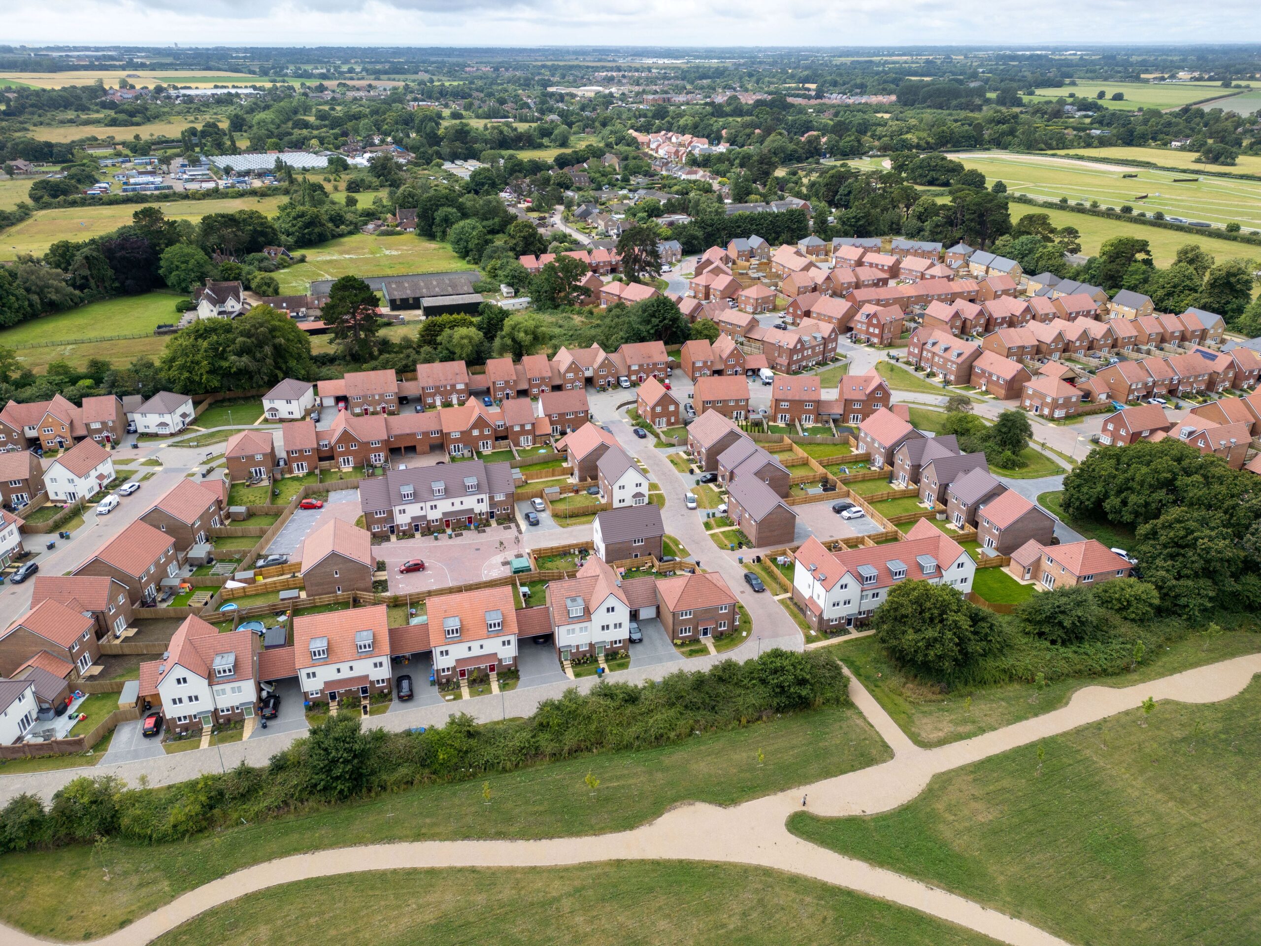 Birds eye view of a rural landscape with a large housing estate