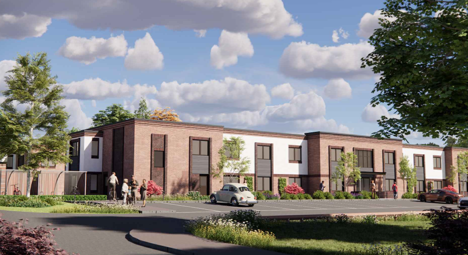 A long shot of a new care home set back with a large car park and grass verge