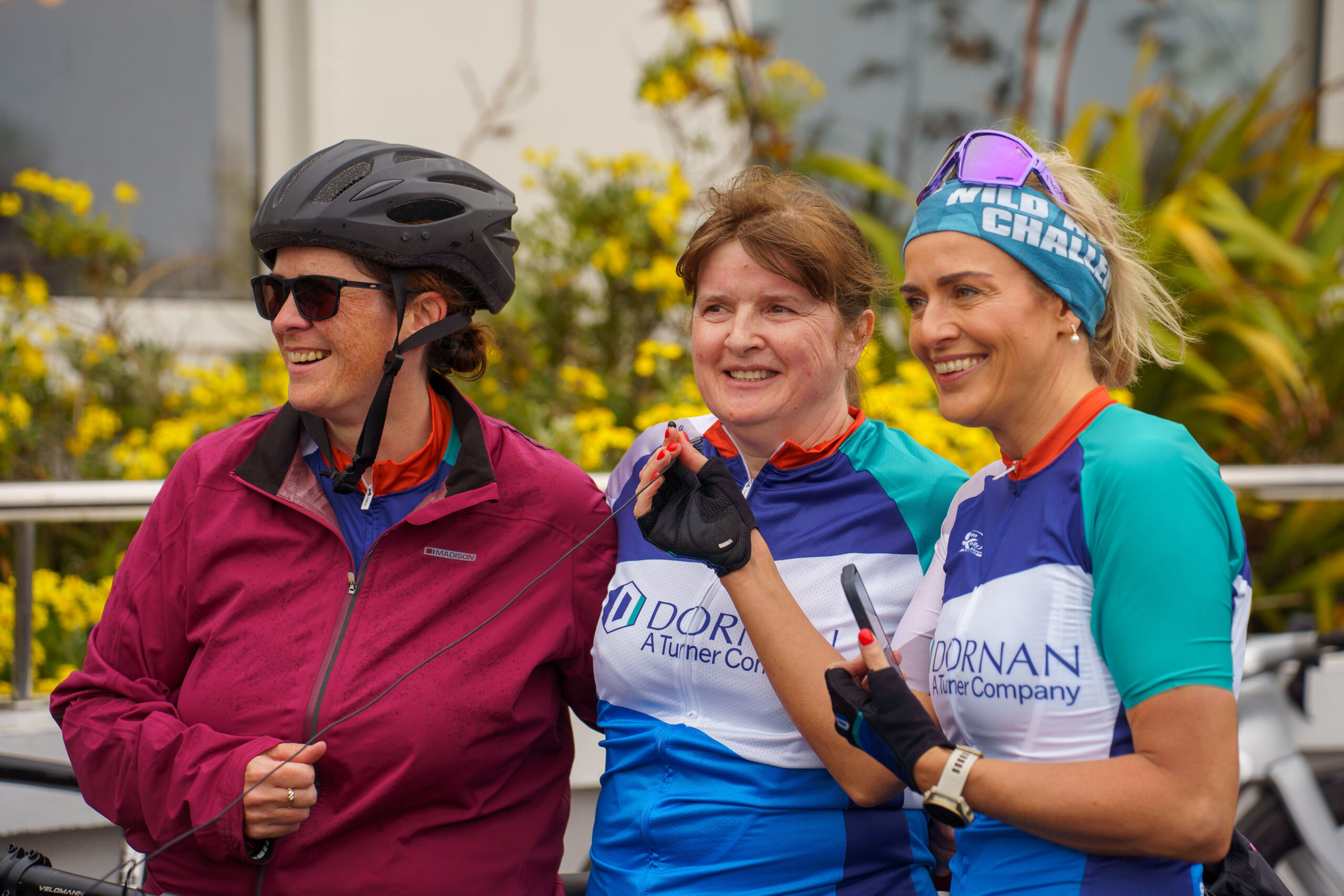 Three women smiling after completing their Sean Kelly charity cycle