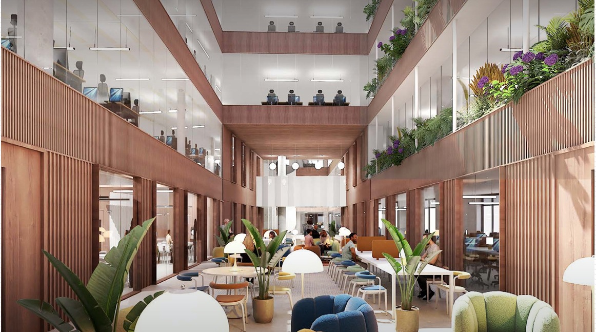 The interior of a new multi-storey office with wooden panelling and large windows with collaborative working spaces on the ground floor