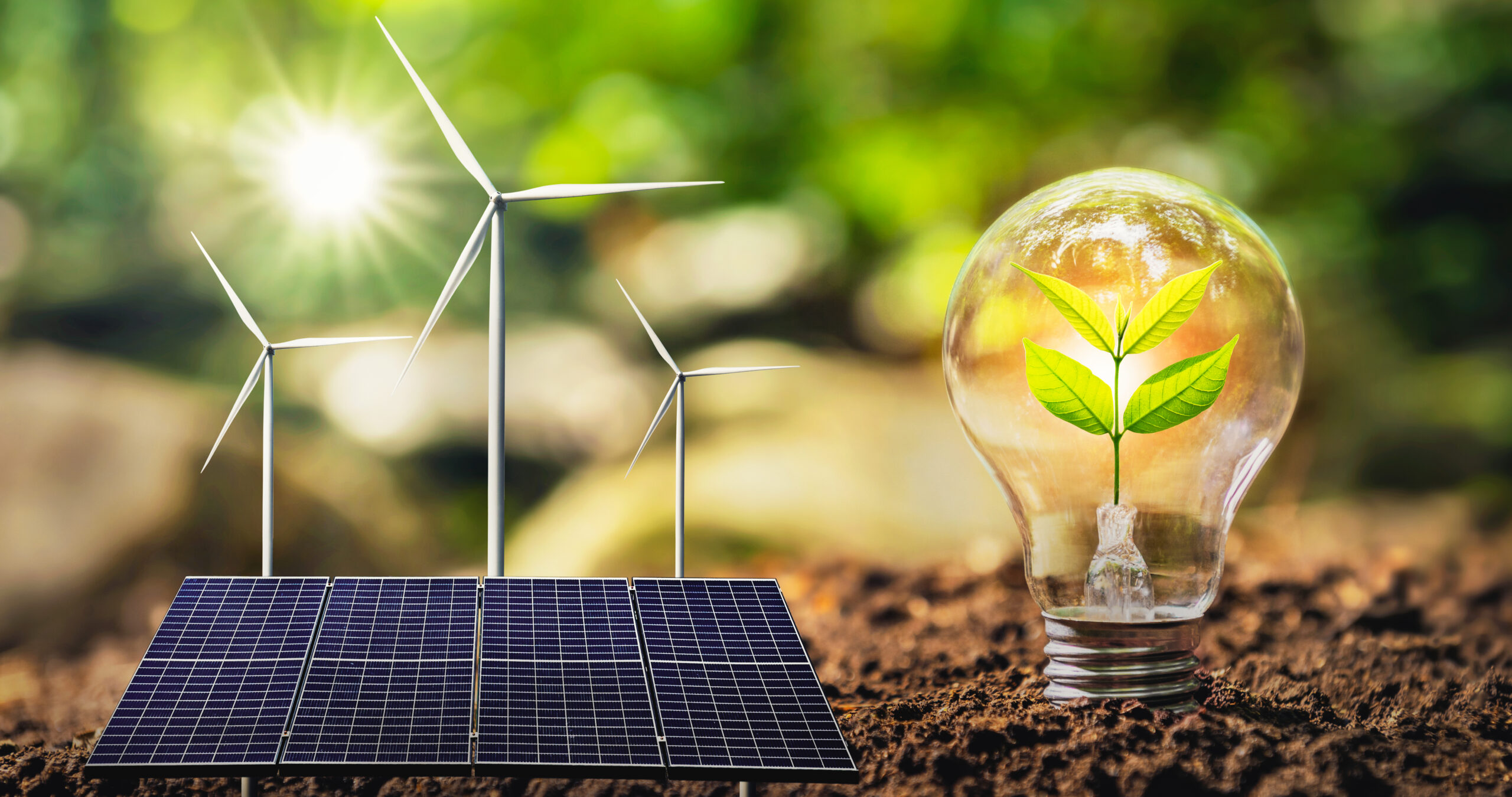 concept clean energy and saving power in nature. solar panel with wind turbine. small tree and lightbulb
