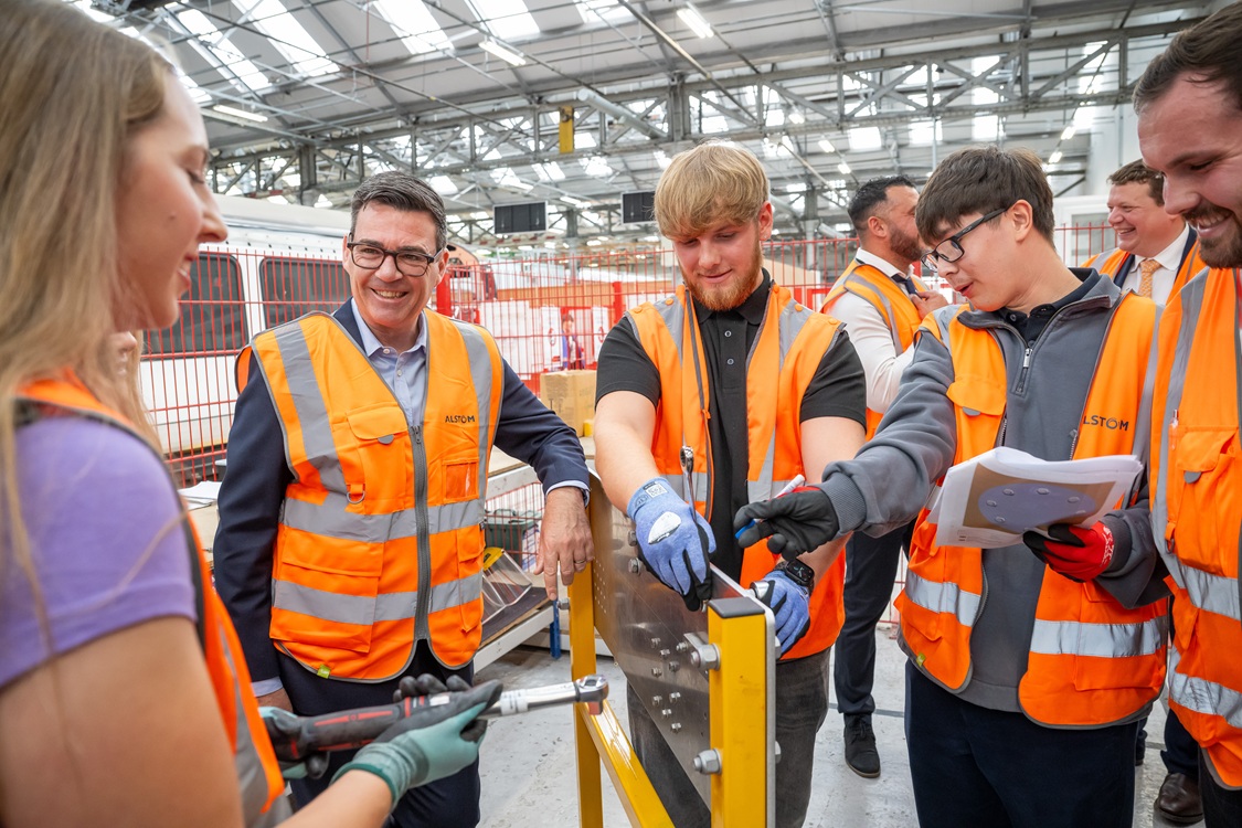 UK Prime Minister Andy Burnham learns torque tightening skills with Alstom apprentice's at the company's National Training Academy at Derby Litchurch Lane Works (Credit – Alstom/Steve Baker)