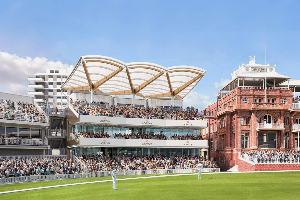 Spectators fill the Allen Stand at Lord’s Cricket Ground beneath its curved canopy, alongside the historic red-brick Pavilion.